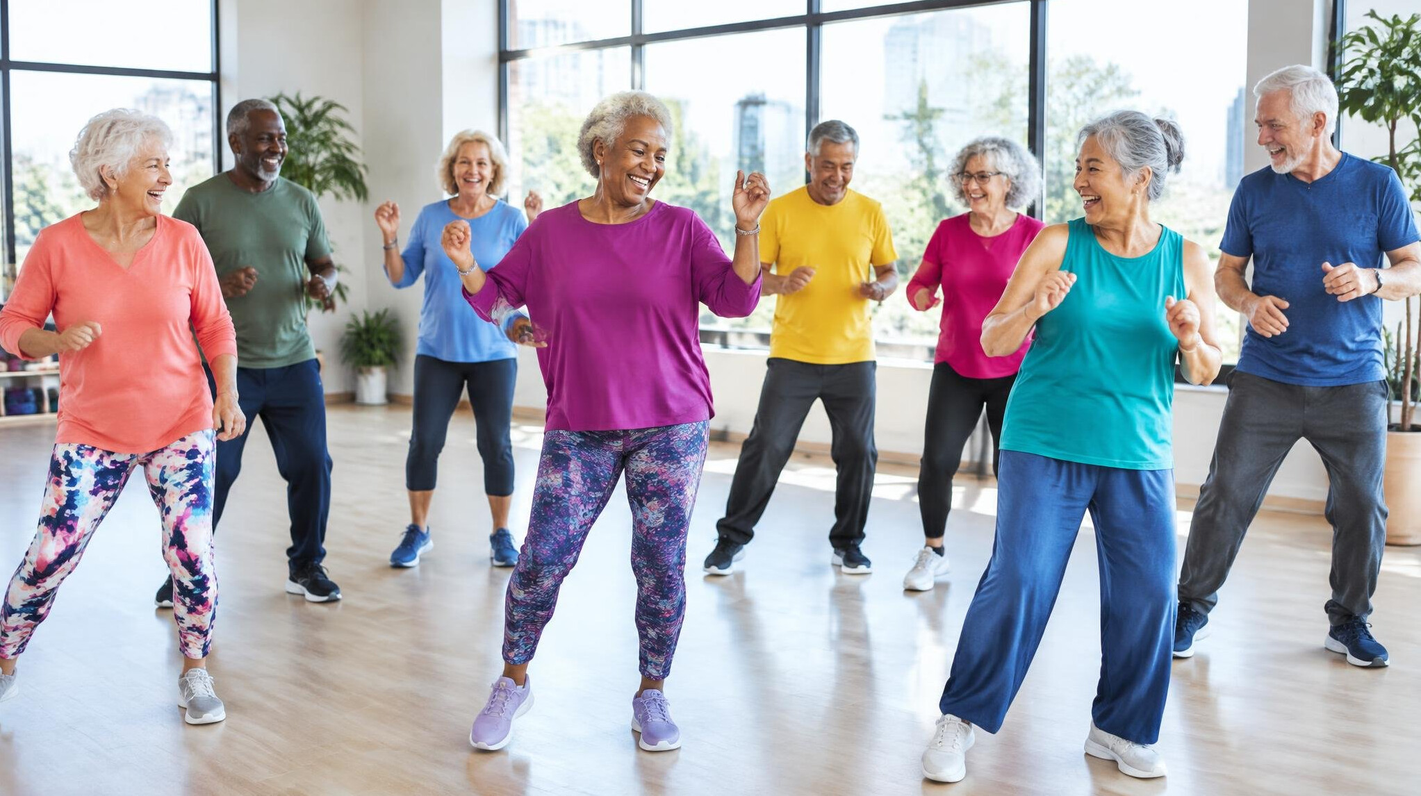 Senior dance class moving together in a bright studio